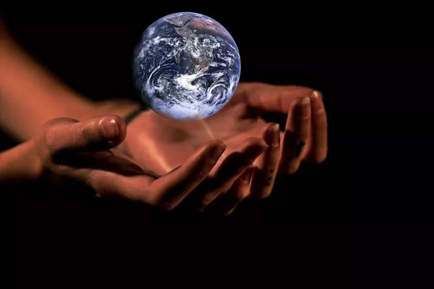 Hands holding the globe. Montage.