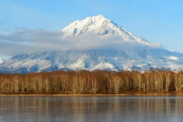 Tundra with a snow-covered volcano in the background. Photo.